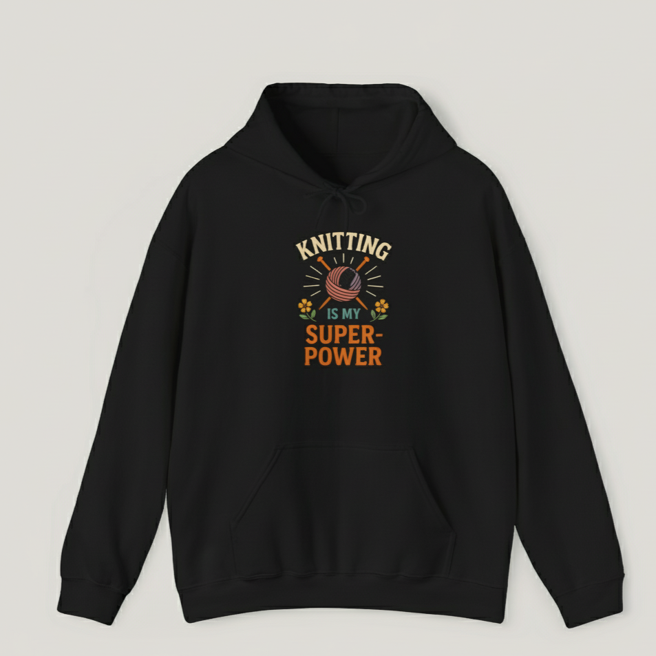 Black hoodie with 'Knitting is my superpower' text and design on a light gray background