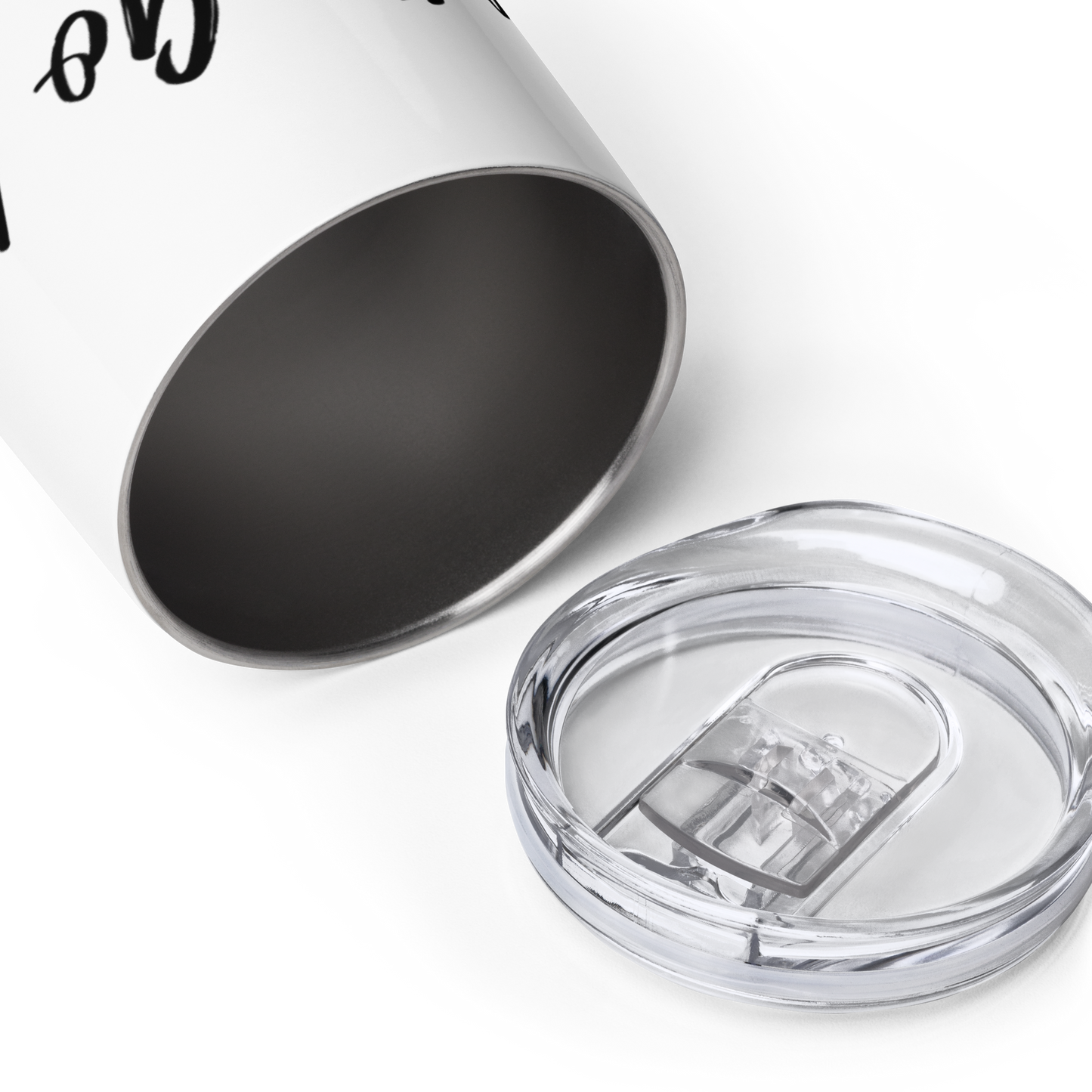 A close up view of a white tumbler with the lid next to it. The mug says "Lets Go Knit" in black letters.