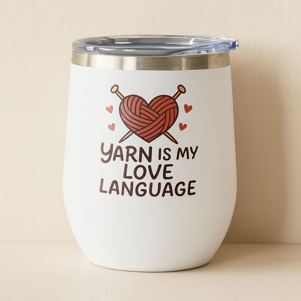 White tumbler with yarn-themed design and text on a beige background