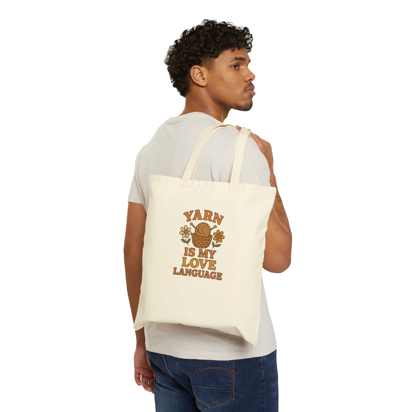 Man carrying a tote bag with 'Yarn is my Love Language' text on a white background