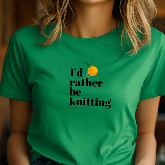 Person wearing a green t-shirt with 'I'd rather be knitting' text and an orange on it.