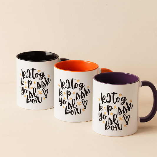 Three mugs with different colored interiors on a beige background.  The colors are black, orange and purple handles and rims.  