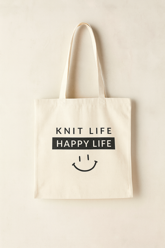 Beige tote bag with 'Knit Life Happy Life' text and smiley face on a beige background