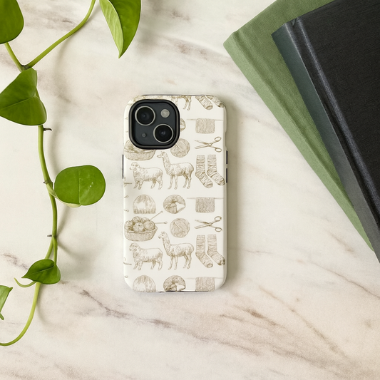 Phone case with animal pattern on a marble surface with books and leaves